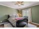 Comfortable bedroom featuring a large window, ceiling fan, and stylish decor at 601 E Palo Verde Dr # 27, Phoenix, AZ 85012