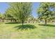 Beautifully landscaped community featuring a pool, green grass, and mature trees at 601 E Palo Verde Dr # 27, Phoenix, AZ 85012
