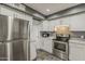 Updated kitchen featuring stainless steel appliances, white cabinets, and modern countertops at 601 E Palo Verde Dr # 27, Phoenix, AZ 85012