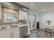 Bright kitchen area with updated stainless appliances and a cozy dining space near the kitchen entrance at 601 E Palo Verde Dr # 27, Phoenix, AZ 85012