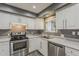 Cozy kitchen with ample natural light, stainless steel appliances, and white cabinets at 601 E Palo Verde Dr # 27, Phoenix, AZ 85012