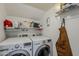 Laundry room contains an overhead shelf and a front loading washer and dryer at 601 E Palo Verde Dr # 27, Phoenix, AZ 85012