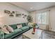 Comfortable living room with a green sofa, attractive decor, and abundant natural light from a window at 601 E Palo Verde Dr # 27, Phoenix, AZ 85012