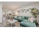 Inviting living room with comfortable green sofa, stylish decor, and an open layout with space for an office at 601 E Palo Verde Dr # 27, Phoenix, AZ 85012