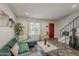 Living room featuring a comfortable green sofa, modern decor, a staircase, and a vibrant red entrance door at 601 E Palo Verde Dr # 27, Phoenix, AZ 85012