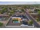 Aerial view of home with a swimming pool, modern design, and green landscaping at 6147 E Desert Cove Ave, Scottsdale, AZ 85254