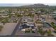 Drone eye-level view of modern home with a pool, set amongst other beautiful homes at 6147 E Desert Cove Ave, Scottsdale, AZ 85254
