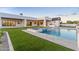 Stunning backyard featuring a large pool, spa, and lush green lawn at 6147 E Desert Cove Ave, Scottsdale, AZ 85254