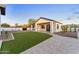 Home's manicured backyard shows artificial turf and inviting facade at 6147 E Desert Cove Ave, Scottsdale, AZ 85254
