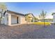 A modern home's exterior featuring a gravel yard, manicured lawn, pool, and minimal, elegant landscaping at 6147 E Desert Cove Ave, Scottsdale, AZ 85254