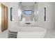 Bright bathroom features a modern soaking tub and glass-enclosed shower with dual shower heads at 6147 E Desert Cove Ave, Scottsdale, AZ 85254
