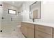 Stylish bathroom featuring a glass shower, modern vanity, and sleek black fixtures at 6147 E Desert Cove Ave, Scottsdale, AZ 85254