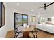 Bright dining area with a modern table, hardwood floors, and views of the outdoor landscaping at 6147 E Desert Cove Ave, Scottsdale, AZ 85254