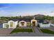 Stunning modern farmhouse with stone accents, black trim, and lush landscaping against a mountain backdrop at 6147 E Desert Cove Ave, Scottsdale, AZ 85254