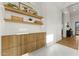 Elegant hallway features floating shelves, wood cabinets, and a stylish white countertop at 6147 E Desert Cove Ave, Scottsdale, AZ 85254