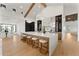Large kitchen island with marble countertops and seating, complemented by modern appliances and decor at 6147 E Desert Cove Ave, Scottsdale, AZ 85254