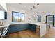 Stylish kitchen featuring blue cabinets, stainless steel appliances, and an island with counter seating at 6147 E Desert Cove Ave, Scottsdale, AZ 85254