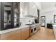 This kitchen features stainless steel appliances, wood cabinets, and a beautiful marble backsplash at 6147 E Desert Cove Ave, Scottsdale, AZ 85254