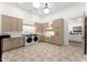 Spacious laundry room with custom cabinets, farmhouse sink, and modern appliances at 6147 E Desert Cove Ave, Scottsdale, AZ 85254