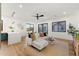 Open-concept living space showcasing a white couch, hardwood floors, and a smooth transition to the dining area at 6147 E Desert Cove Ave, Scottsdale, AZ 85254