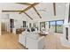Open-concept kitchen and living room with exposed wood beams and large sliding glass doors to the pool at 6147 E Desert Cove Ave, Scottsdale, AZ 85254