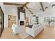 Bright, spacious living room featuring a modern fireplace, exposed wood beams, and an open layout at 6147 E Desert Cove Ave, Scottsdale, AZ 85254