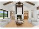 Spacious living room with wood beams, fireplace, and built-in shelving, perfect for relaxation and entertainment at 6147 E Desert Cove Ave, Scottsdale, AZ 85254