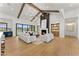 Bright, spacious living room with exposed wood beams, modern fireplace, and access to the backyard at 6147 E Desert Cove Ave, Scottsdale, AZ 85254