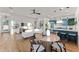 Open-concept living space featuring a dining area, living room, and modern kitchen with hardwood floors at 6147 E Desert Cove Ave, Scottsdale, AZ 85254
