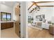 Bright main bedroom suite featuring high ceilings, wood beams, ensuite bathroom and contemporary decor at 6147 E Desert Cove Ave, Scottsdale, AZ 85254