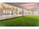 Spacious covered patio with wood ceilings, expansive glass doors, and ample space for outdoor living at 6147 E Desert Cove Ave, Scottsdale, AZ 85254