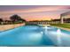 Tranquil pool with water features and a spa, surrounded by greenery, creating a peaceful outdoor oasis at 6147 E Desert Cove Ave, Scottsdale, AZ 85254