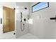 Bright white stand up shower features sleek fixtures, white tiles and glass door enclosure at 6147 E Desert Cove Ave, Scottsdale, AZ 85254