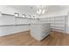 Large walk-in closet features modern shelving and a central island with ample storage at 6147 E Desert Cove Ave, Scottsdale, AZ 85254