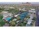 Aerial view of a resort and recreational facilities including a swimming pool and multiple tennis courts at 6207 E Rose Circle Dr, Scottsdale, AZ 85251