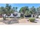 Lovely single-story home with an attached garage, flower boxes, and mature landscaping under a blue sky at 6207 E Rose Circle Dr, Scottsdale, AZ 85251