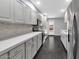 Beautiful kitchen featuring stainless steel appliances, gray cabinetry, and a stylish tiled backsplash at 6207 E Rose Circle Dr, Scottsdale, AZ 85251