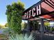 Inviting outdoor patio area with ample seating, shade, and lush greenery for a relaxing dining experience at 6207 E Rose Circle Dr, Scottsdale, AZ 85251