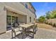Backyard with covered patio, lounge furniture, a large outdoor dining table and stone pavers at 6503 E Bluefield Ave, Phoenix, AZ 85054