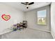 Bedroom with neutral walls, carpet and ceiling fan with black blades at 6503 E Bluefield Ave, Phoenix, AZ 85054