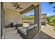 Covered patio with outdoor furniture, ceiling fan, and a well maintained gravel yard at 6503 E Bluefield Ave, Phoenix, AZ 85054