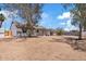 Spacious backyard with mature trees offering shade, and potential for a beautiful outdoor oasis at 6863 W Sunnyside Dr, Peoria, AZ 85345