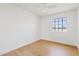 Bright bedroom with a large window offering neighborhood views and wood-look flooring at 6863 W Sunnyside Dr, Peoria, AZ 85345