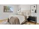 Cozy bedroom featuring a comfortable bed, side tables, and soft natural light from the window at 6863 W Sunnyside Dr, Peoria, AZ 85345