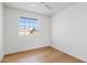 Bright bedroom with a large window offering neighborhood views and wood-look flooring at 6863 W Sunnyside Dr, Peoria, AZ 85345