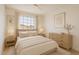 Bright bedroom featuring neutral tones, a large window, and stylish furnishings for a serene living space at 6863 W Sunnyside Dr, Peoria, AZ 85345