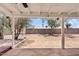 Covered patio with desert landscaping beyond, offering an ideal space for outdoor enjoyment at 6863 W Sunnyside Dr, Peoria, AZ 85345