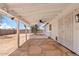 A spacious covered patio with stone flooring and a ceiling fan to keep you cool on hot days at 6863 W Sunnyside Dr, Peoria, AZ 85345