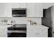 Modern kitchen features stainless steel appliances and white quartz countertops at 6863 W Sunnyside Dr, Peoria, AZ 85345