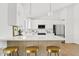 Bright kitchen with white cabinets, quartz countertops, and stainless steel appliances at 6863 W Sunnyside Dr, Peoria, AZ 85345